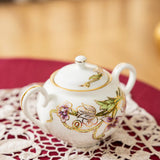 Decorative sugar bowl with floral patterns on a lace doily