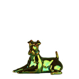 A small metallic figurine of a lying dog with a reflective iridescent finish, shown against a plain white background.
