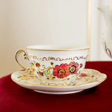 Decorative teacup with floral patterns on a saucer against a neutral background