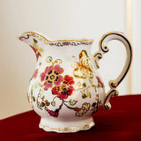 Decorative teapot with floral patterns on a red surface