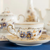 Decorative teacup with floral patterns on a blue surface