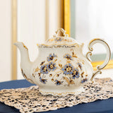 Decorative teapot with floral patterns on a doily