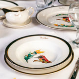 Dinnerware set with bird designs on a table setting.