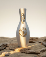 Decorative vase with gold patterns on a rocky surface