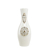 A white porcelain vase with gold-plated ornamental details and a floral pattern on the front.
