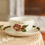 Teacup with floral design on a saucer on a textured surface