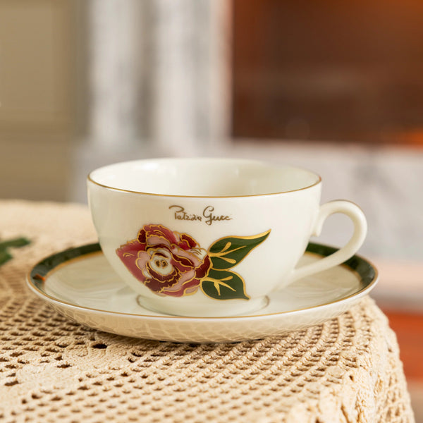 Teacup with floral design on a saucer on a textured surface