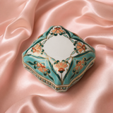 Decorative hexagonal box with floral patterns on a pink satin background