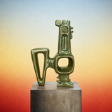 Green abstract sculpture on a gray pedestal against a gradient background