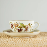 Ceramic cup with floral design on a textured surface