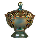 A handcrafted ceramic bonboniere with Zsolnay Eozin Glaze, featuring a intricate pierced design and a turquoise color.