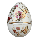 Hand-painted Zsolnay Butterfly porcelain egg-shaped bonbonier with lid, decorated with pink and yellow floral motifs and gold accents, resting on pink rose petals.