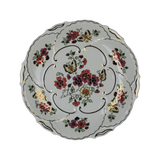 Large hand-painted Zsolnay Butterfly porcelain wall plate featuring pink and yellow floral motifs, butterflies, and a gold scalloped border, resting on pink rose petals.