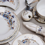 Zsolnay Cornflower dinner set featuring hand-painted blue floral plates and gold-trimmed porcelain.